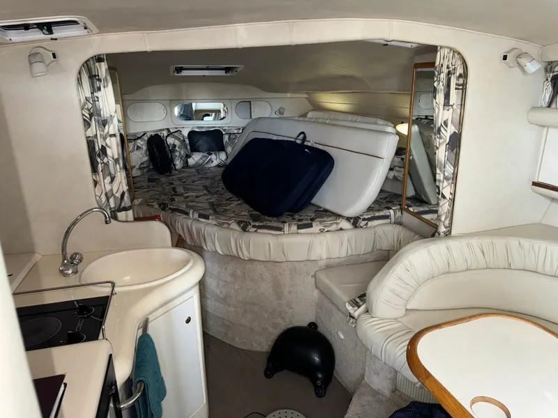 Slide: The Image of Interior of 1997 Sea Ray 330 Sundancer boat with cozy seating and compact kitchen area. - 18