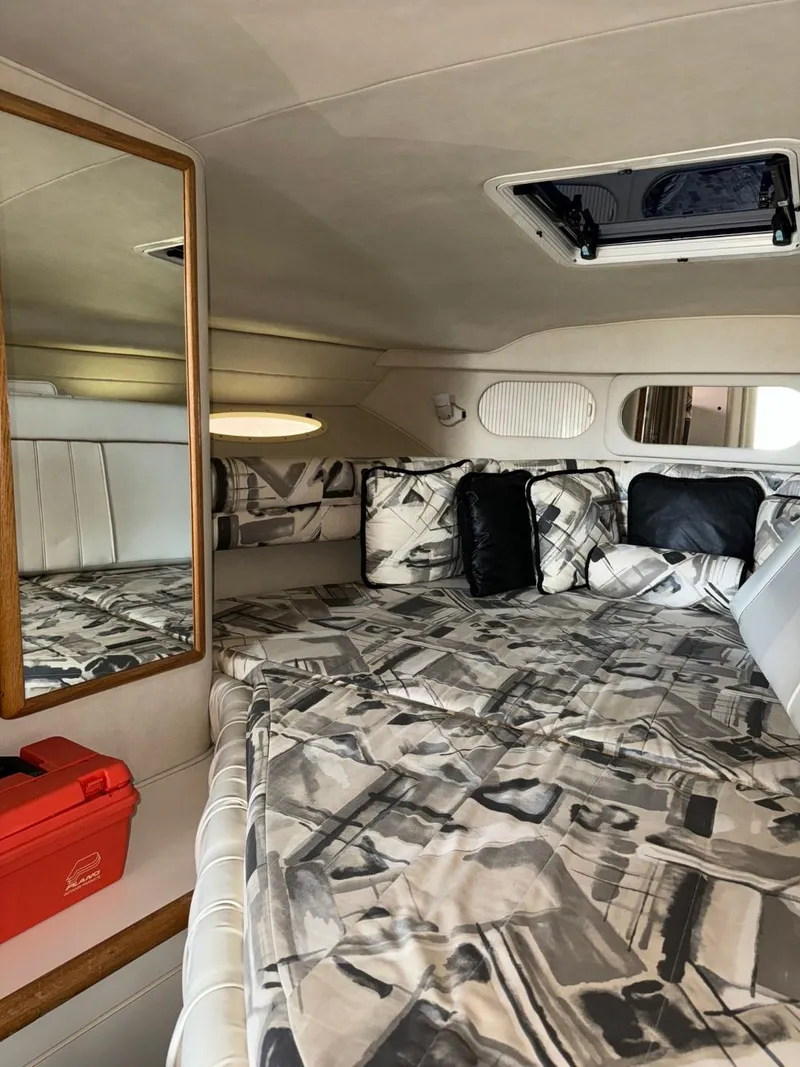 Slide: The Image of Interior cabin of 1997 Sea Ray 330 Sundancer with patterned bedding and a mirror. - 19