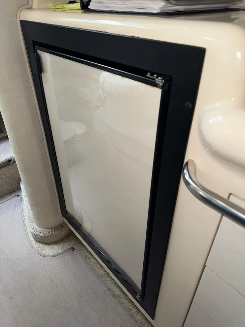 Slide: The Image of 1997 Sea Ray 330 Sundancer interior with a built-in refrigerator. - 23