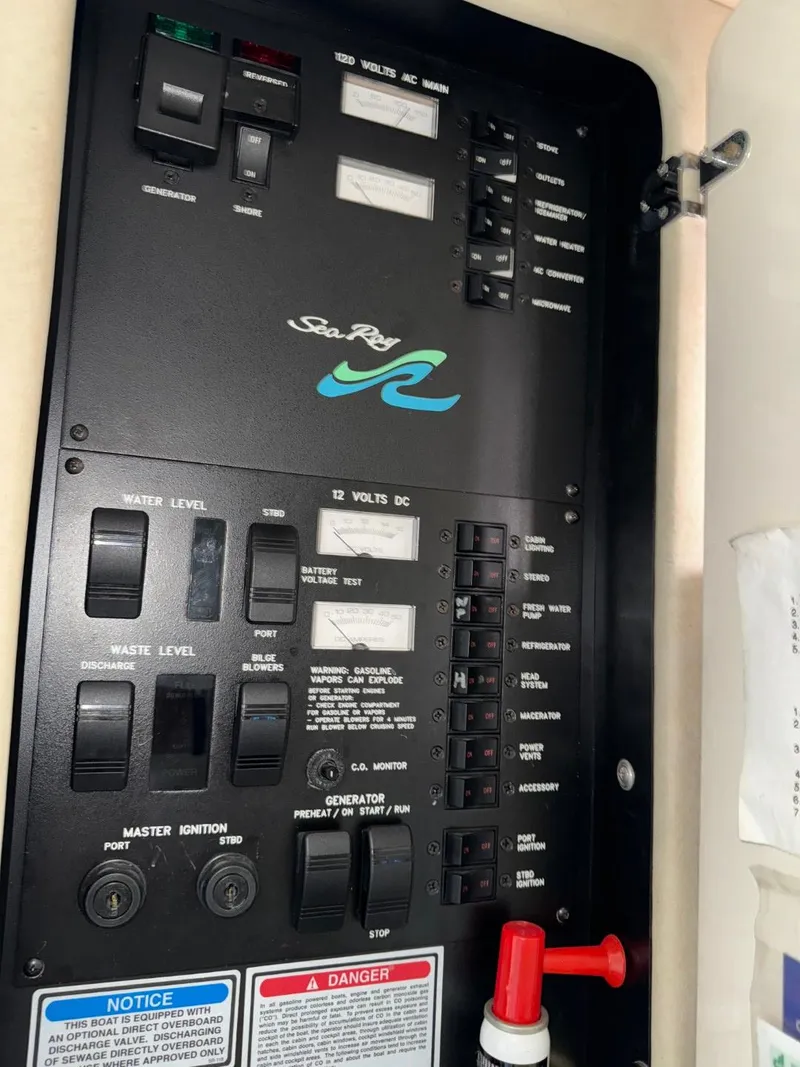Slide: The Image of Control panel of a 1997 Sea Ray 330 Sundancer boat, featuring various switches and indicators. - 24