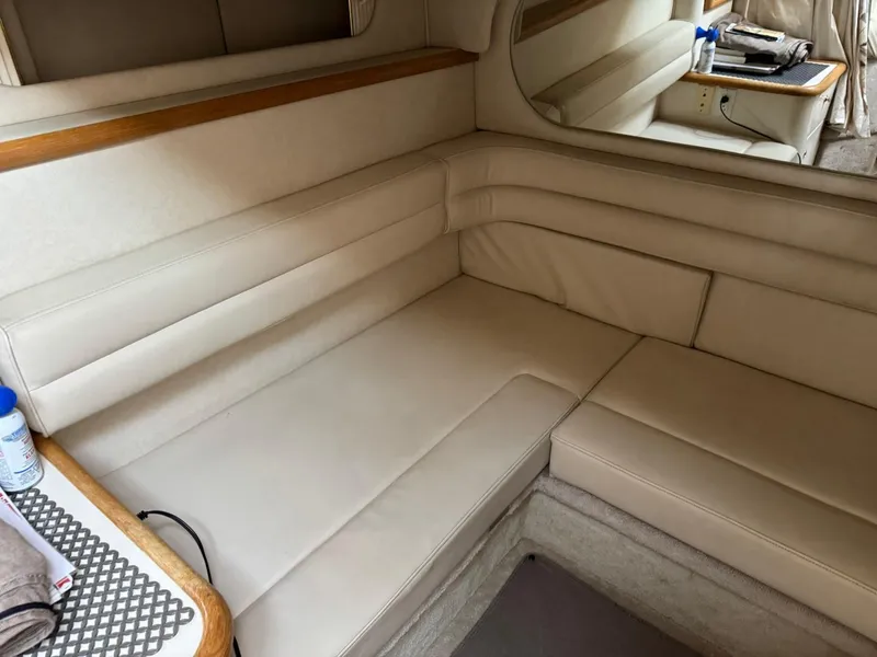 Slide: The Image of Interior of 1997 Sea Ray 330 Sundancer with beige seating and wooden accents. - 26