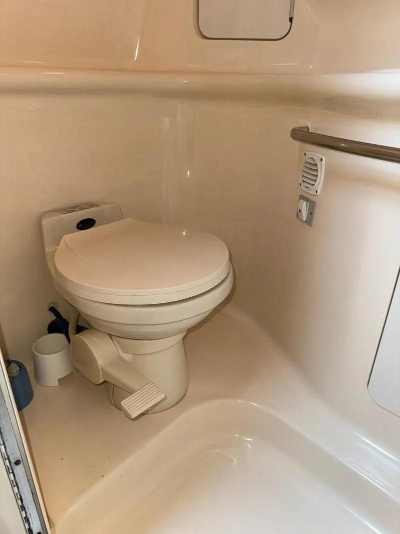 Slide: The Image of 1997 Sea Ray 330 Sundancer bathroom with toilet and handrail. - 30