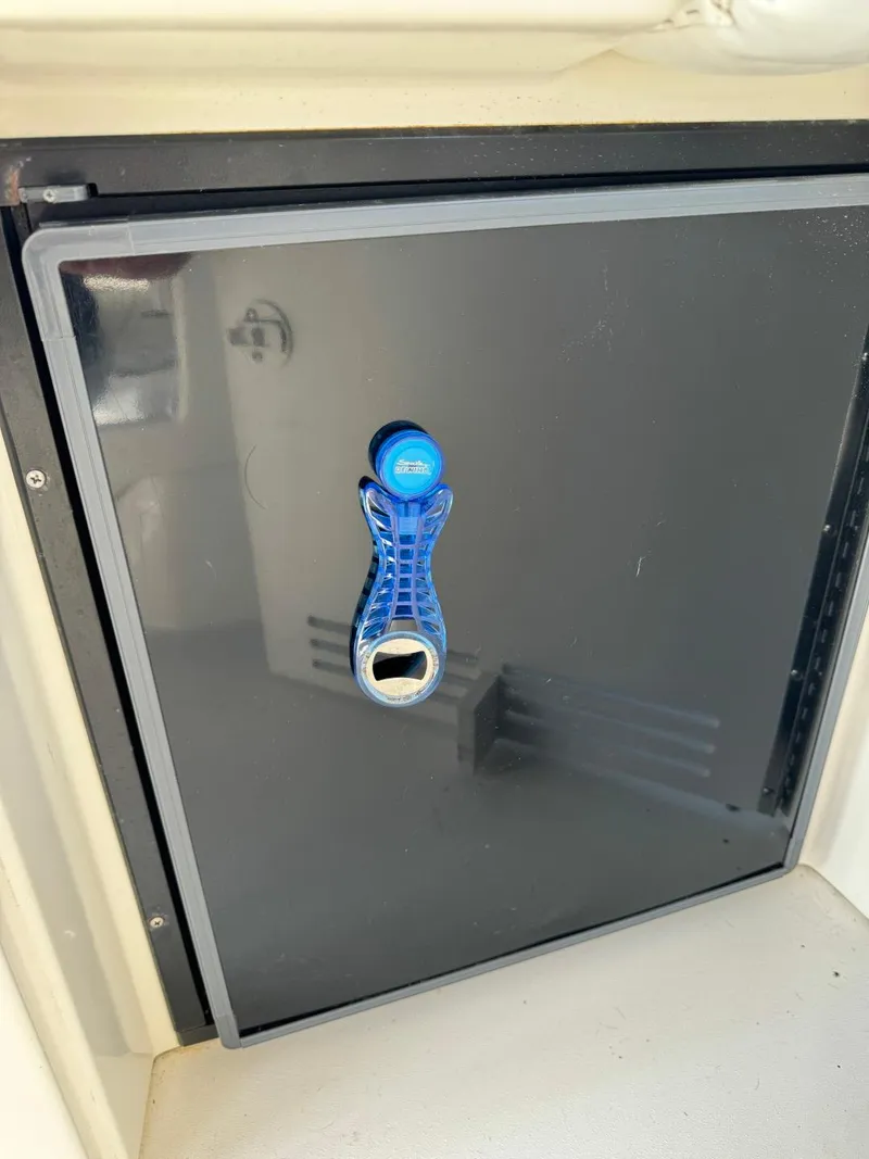 Slide: The Image of Black compartment door on 1997 Sea Ray 330 Sundancer boat. - 31