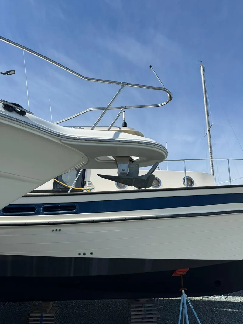 Slide: The Image of 1997 Sea Ray 330 Sundancer yacht on dry dock under clear blue sky. - 33
