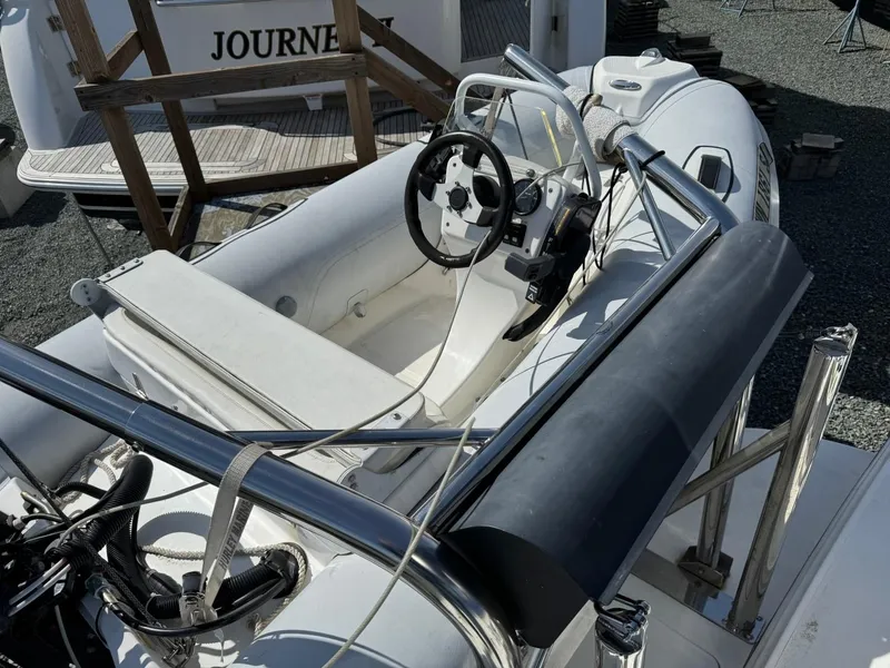 Slide: The Image of 1997 Sea Ray 330 Sundancer boat interior with steering wheel and seating area. - 4
