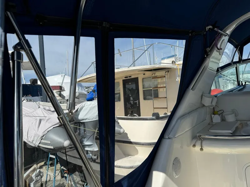 Slide: The Image of 1997 Sea Ray 330 Sundancer interior view with marina background. - 8