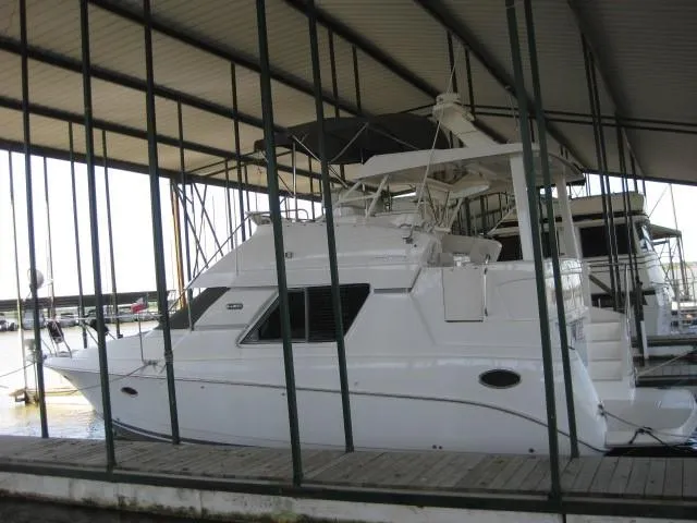 The Image of 1999 Silverton 352 Motor Yacht docked in a marina, side view. - 0