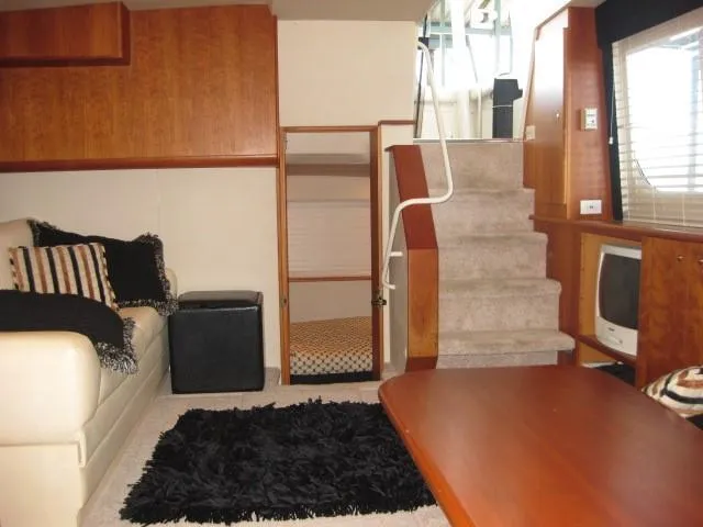 Slide: The Image of 1999 Silverton 352 Motor Yacht docked with green underwater lights and deck view. - 10