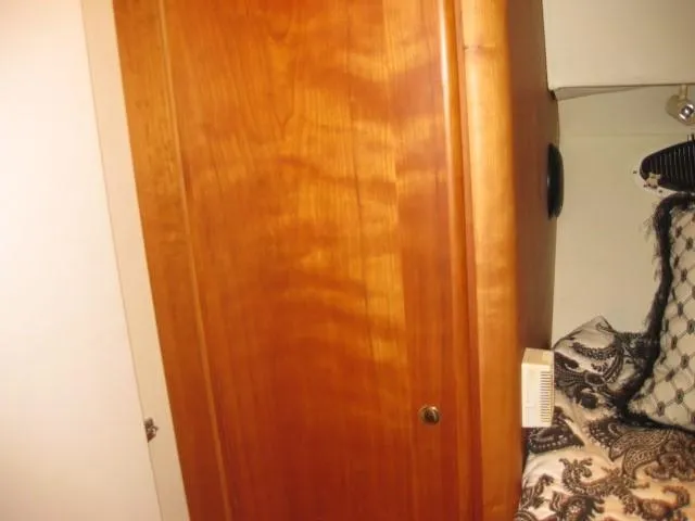 Slide: The Image of Interior of a 1999 Silverton 352 Motor Yacht with cozy seating and kitchen area. - 13