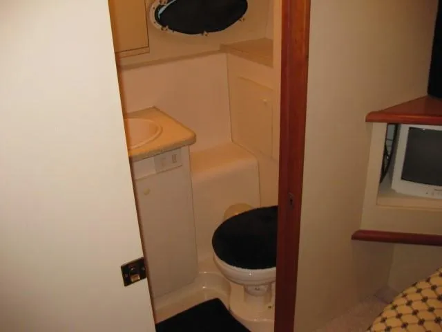 Slide: The Image of Bathroom interior of 1999 Silverton 352 Motor Yacht with sink and shower area. - 18