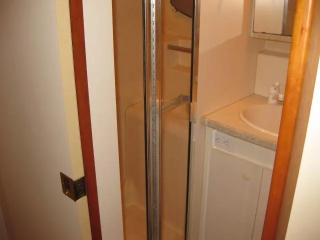 Slide: The Image of Cozy bedroom in 1999 Silverton 352 Motor Yacht with nautical-themed bedding and decor. - 19