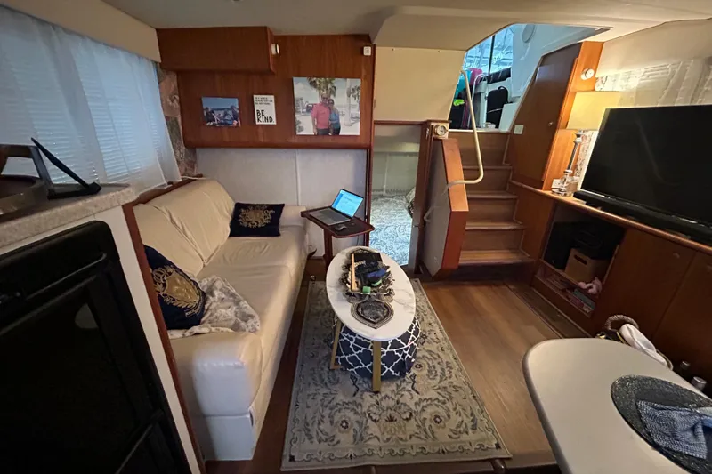 Slide: The Image of Interior of a 1999 Silverton 352 Motor Yacht with cozy seating and modern amenities. - 23
