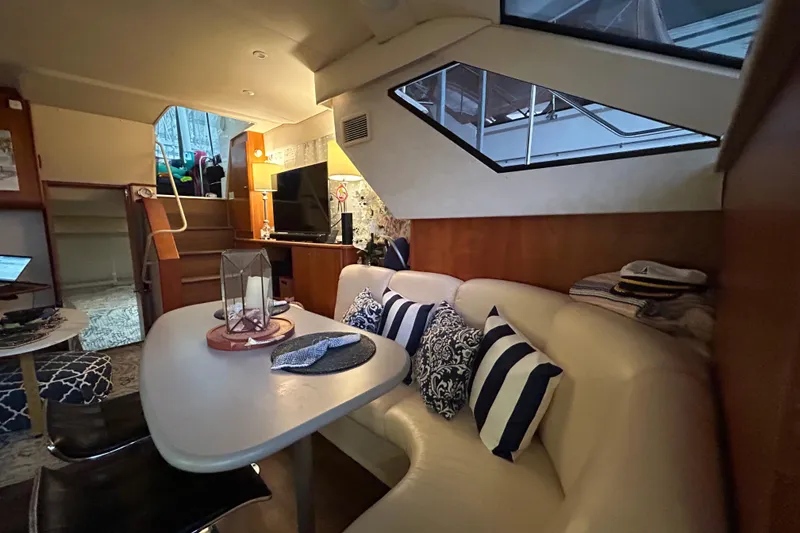 Slide: The Image of Interior of 1999 Silverton 352 Motor Yacht with cozy seating and nautical decor. - 24