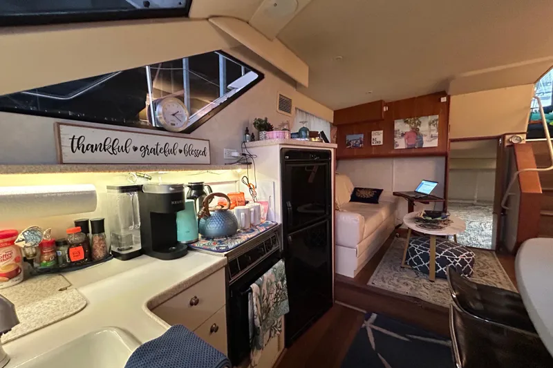 Slide: The Image of Interior of a 1999 Silverton 352 Motor Yacht with cozy kitchen and living area. - 25
