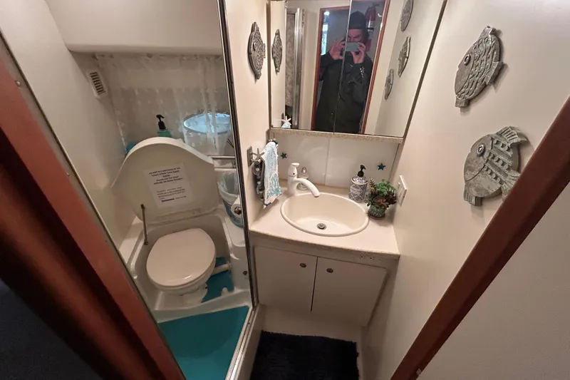 Slide: The Image of Bathroom interior of 1999 Silverton 352 Motor Yacht with nautical decor. - 27