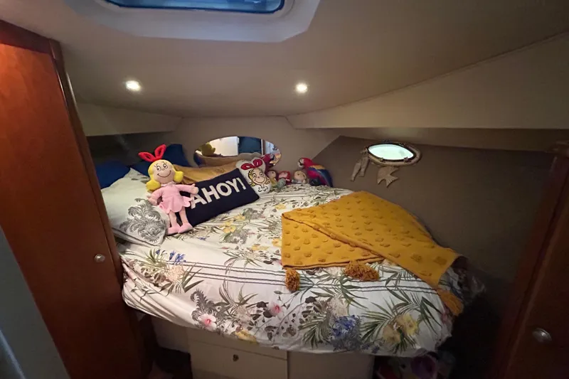 Slide: The Image of Cozy cabin interior of 1999 Silverton 352 Motor Yacht with plush toys and decorative pillows. - 29