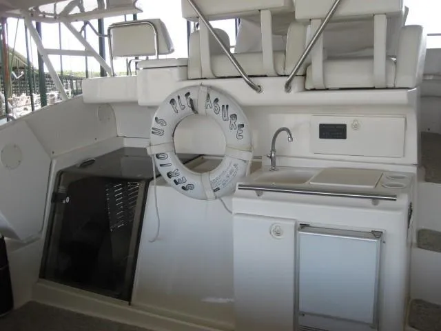 Slide: The Image of 1999 Silverton 352 Motor Yacht docked in a covered marina. - 3