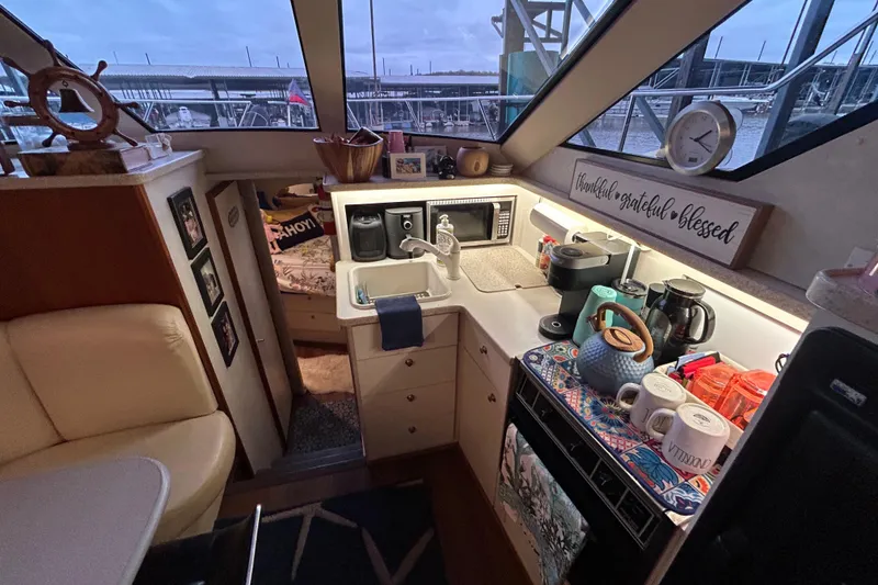 Slide: The Image of Interior of a 1999 Silverton 352 Motor Yacht kitchen with appliances and decor. - 31