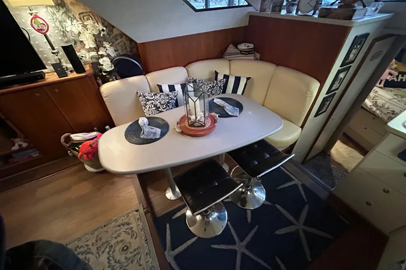Slide: The Image of Interior of a 1999 Silverton 352 Motor Yacht with cozy dining area and stylish decor. - 32