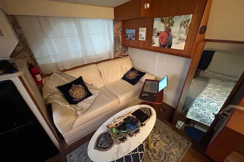 Slide: The Image of Interior of 1999 Silverton 352 Motor Yacht with cozy seating and decor. - 34