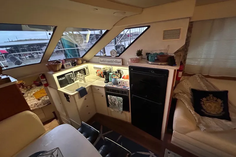 Slide: The Image of Interior of a 1999 Silverton 352 Motor Yacht with kitchen and seating area. - 35