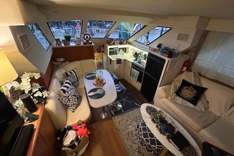 Slide: The Image of Interior of a 1999 Silverton 352 Motor Yacht with cozy seating and modern amenities. - 36