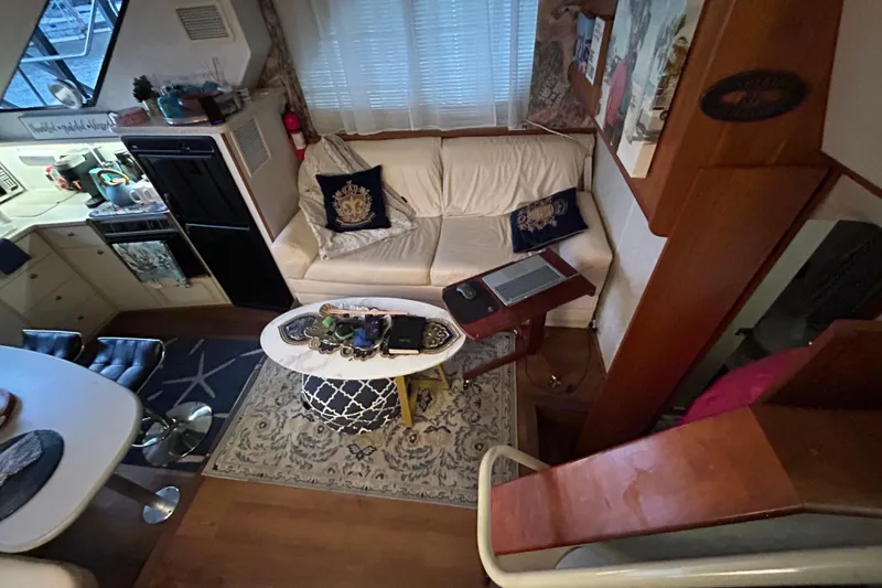 Slide: The Image of Interior of a 1999 Silverton 352 Motor Yacht with cozy seating and nautical decor. - 37