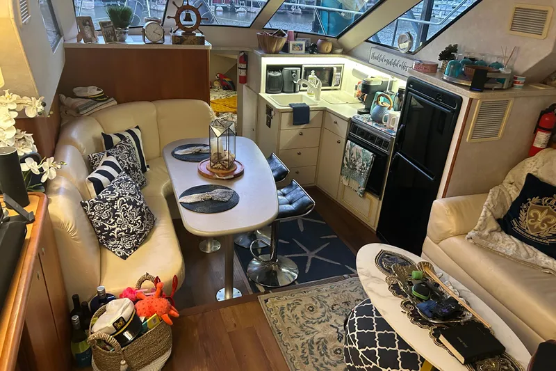 Slide: The Image of Interior of a 1999 Silverton 352 Motor Yacht with cozy seating and kitchen area. - 38