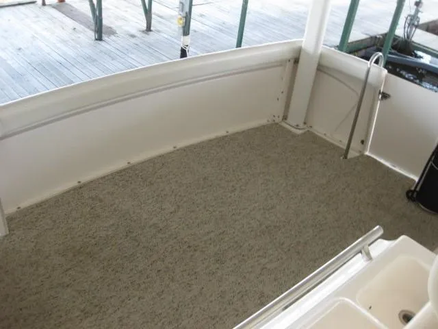 Slide: The Image of 1999 Silverton 352 Motor Yacht docked in a marina under a covered structure. - 4