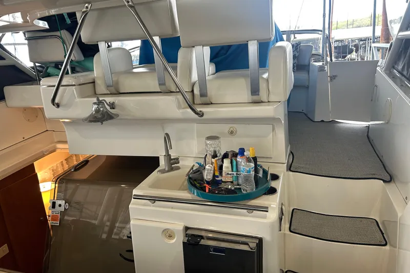 Slide: The Image of 1999 Silverton 352 Motor Yacht interior with seating, sink, and accessories. - 43