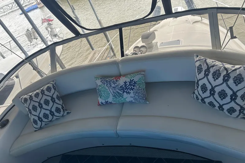 Slide: The Image of 1999 Silverton 352 Motor Yacht interior with decorative pillows on curved seating. - 44