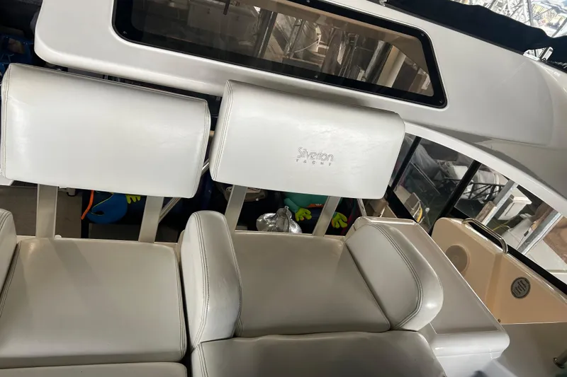 Slide: The Image of Interior seating of a 1999 Silverton 352 Motor Yacht with white upholstery. - 46