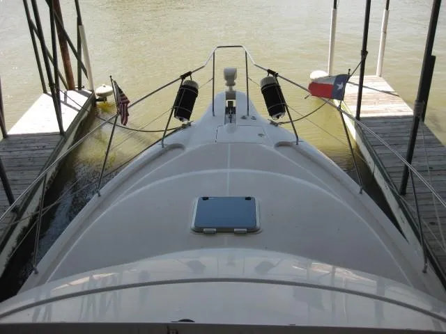 Slide: The Image of 1999 Silverton 352 Motor Yacht docked in a covered marina. - 5