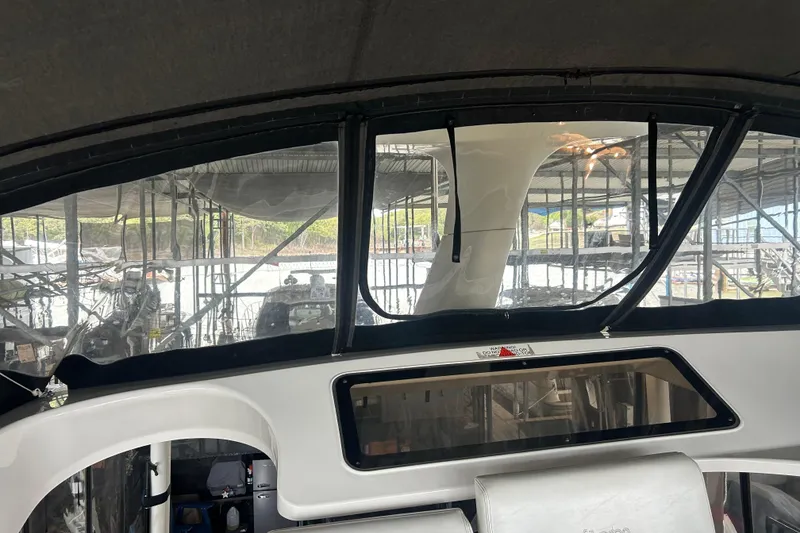 Slide: The Image of Interior view of a 1999 Silverton 352 Motor Yacht with clear windows and seating. - 50