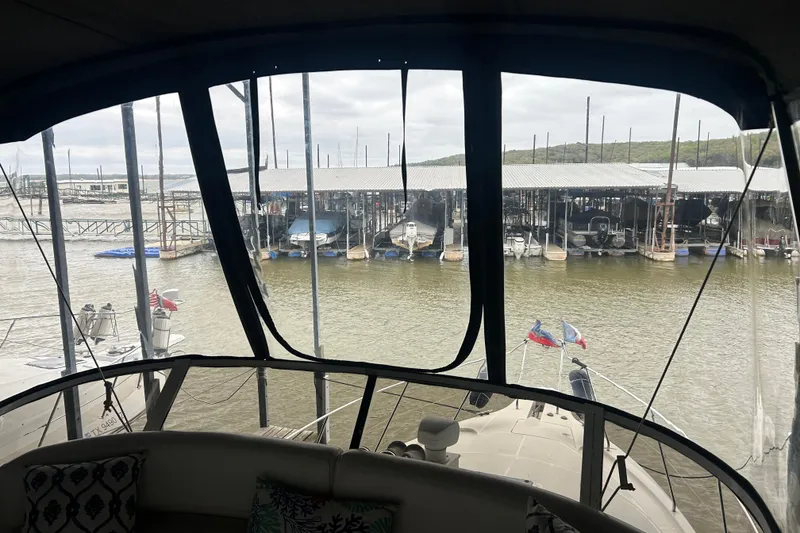 Slide: The Image of 1999 Silverton 352 Motor Yacht docked at marina, view from interior helm. - 52