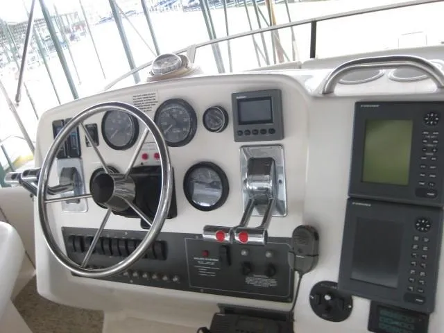 Slide: The Image of 1999 Silverton 352 Motor Yacht docked in a marina with string lights above. - 8