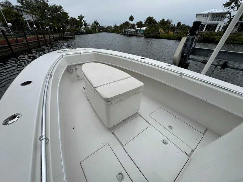 Slide: The Image of 2000 Contender 25 Open boat, spacious deck, canal view, white interior, calm water setting. - 20