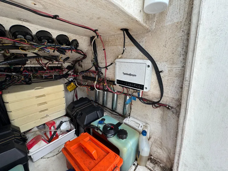 Slide: The Image of Electrical wiring and storage inside a 2000 Contender 25 Open boat. - 27