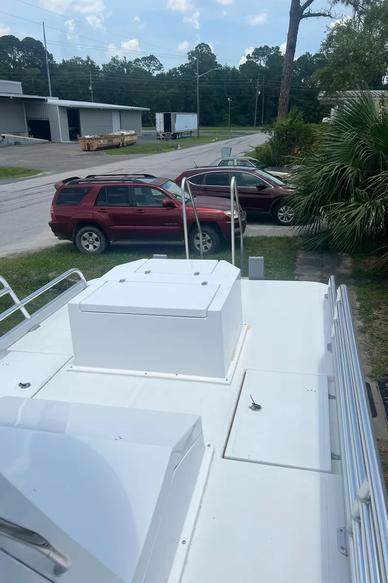 Slide: The Image of Mirage Bay Cat 26 boat, 2022 model, parked beside SUVs. - 7