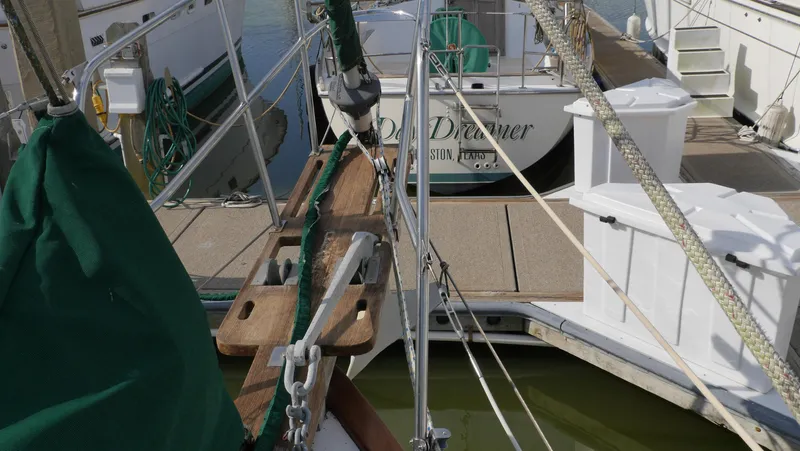 Slide: The Image of 1979 Tayana 37 sailboat docked, featuring deck and rigging details. - 18