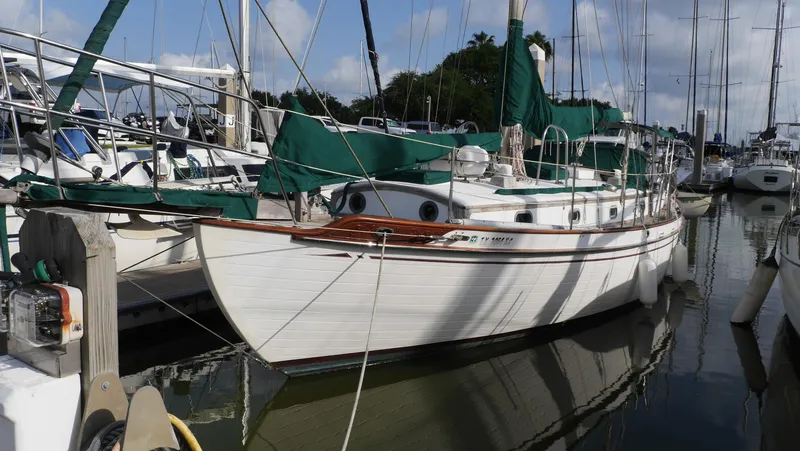 The Image of 1979 Tayana 37 sailboat docked at marina under clear skies. - 0