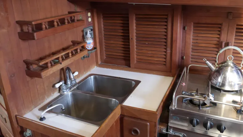 Slide: The Image of Wooden galley kitchen in 1979 Tayana 37 sailboat with sink and stove. - 31