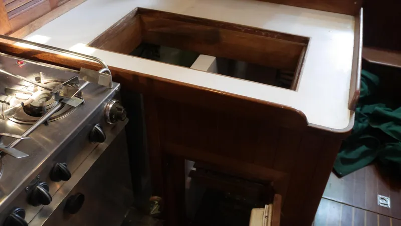 Slide: The Image of 1979 Tayana 37 yacht galley with stove and countertop space. - 36