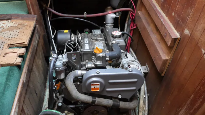 Slide: The Image of Engine compartment of a 1979 Tayana 37 sailboat, showcasing mechanical components and wiring. - 29