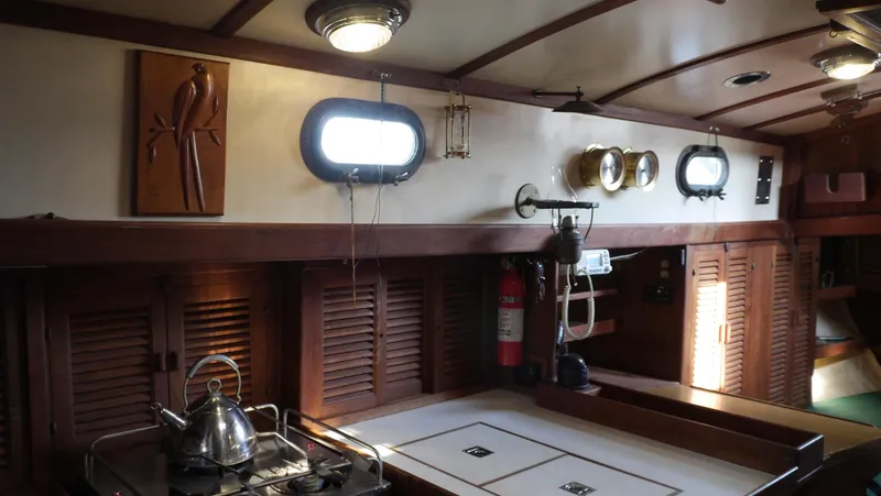 Slide: The Image of Interior of 1979 Tayana 37 sailboat with wooden cabinetry and nautical decor. - 33