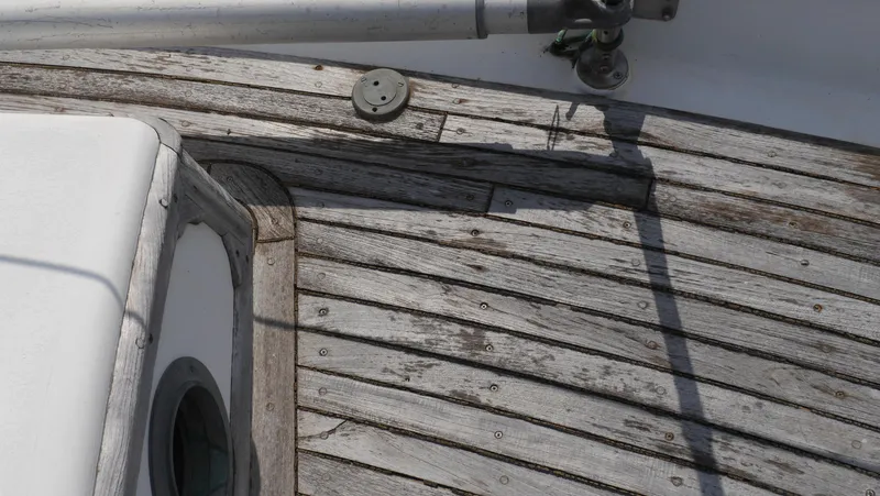 Slide: The Image of Weathered wooden deck of a 1979 Tayana 37 sailboat. - 20