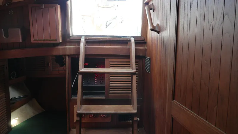 Slide: The Image of Interior of 1979 Tayana 37 sailboat with wooden ladder and paneling. - 49