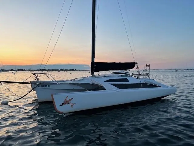 The Image of 1987 Corsair F-27 trimaran sailboat on calm water at sunset. - 0