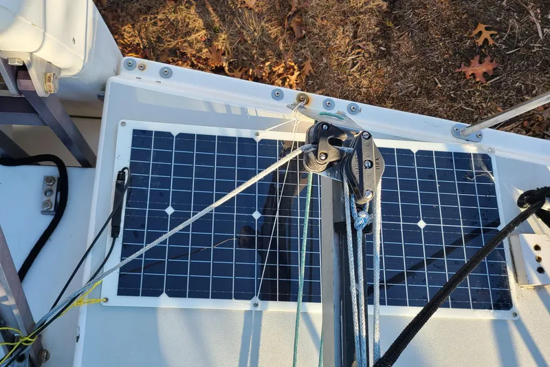 Slide: The Image of Solar panels on a 1987 Corsair F-27 sailboat deck with rigging ropes. - 18
