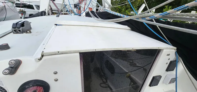 Slide: The Image of 1987 Corsair F-27 sailboat deck with rigging and cabin entrance. - 7